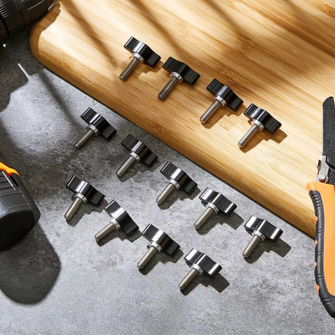 Top Shelf Stainless Steel Thumb Screws With Wings Knobs For Shop Projects 16 Pack laid out on a work surface with tools.