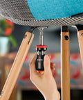 Person using Stubby Ratcheting Screwdriver Kit With 14-In-1 Mini Bit Set Including Flathead, Hex, Torx, Square, And Pozidriv Tips Compact Black And Red Dope Handy Tool For Quick Fixes And Electronics Projects to tighten chair screw indoors.