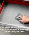 Professional Toolbox Drawer Liner Gray Non Slip Foam Rubber Mat With Easy Cut Grid Lines For Measuring And Cutting Thick Cabinet Liner Seventeen And Three Eighths Inch Wide 24 Feet Long being wiped clean in drawer