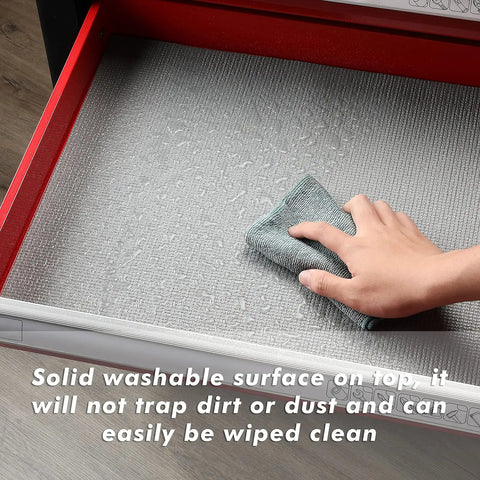 Hand cleaning a drawer with Heavy Duty Tool Box Liner And Drawer Liner With Grippy Non Slip Foam For Scratch Protection