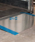 Rock Solid 60 By 48 Inch Aluminum Dock Plate Trailer Ramp With Bolt On Steel Legs resting on concrete for smooth loading.