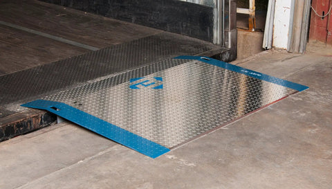 Rock Solid 60 By 48 Inch Aluminum Dock Plate Trailer Ramp With Bolt On Steel Legs resting on concrete for smooth loading.