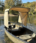 Beige Canoe And Kayak Sun Shade Canopy Bimini Top In Conestoga Wagon Style on water with zippered side curtains.