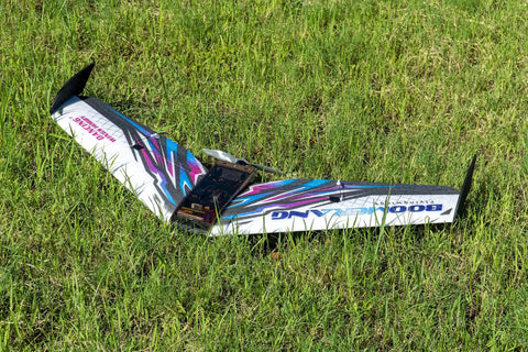 FPV Delta Wing RC Airplane Kit With 1114mm Wingspan EPP Foam Build resting on grass, showcasing tail pusher glider design.