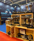 Trade show booth displaying Stubby 1/2 Inch Air Impact Wrench With Jumbo Hammer Grip, Beast Torque 550-650 Ft-Lb on wooden shelves.