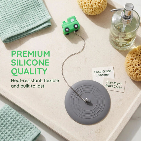 TEHAUX Silicone Bathtub Drain Stopper 15cm with playful tractor design on a countertop for bathroom use.