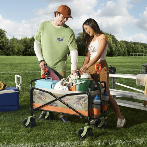 Two people using a Heavy-Duty Collapsible Beach Wagon with All Terrain Wheels and Large Storage on a grassy field.