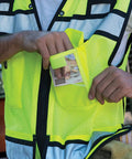 Rock Solid Hi Vis Surveyor Vest With Zipper Front Closure Ansi Class Two Type R Certified Lime Polyester Reflective Safety Vest Featuring Kickass Stripes And Hefty Tool Pockets For Xl, showing pocket use.