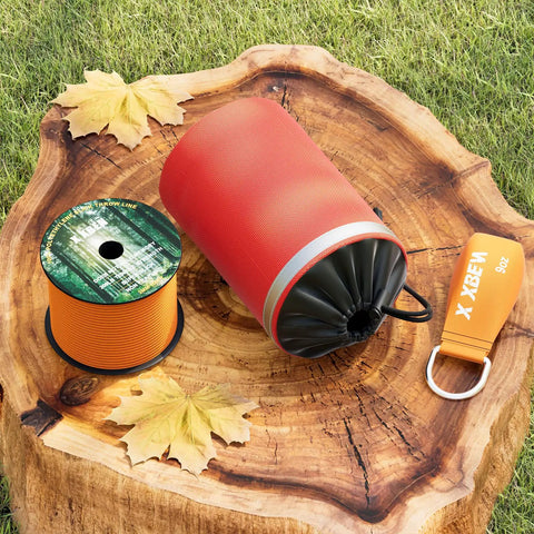 Arborist Throw Line Kit With 15 Oz Throw Weight, 150 Ft Slick Polyester Rope, Reflective Orange Storage Bag on tree stump