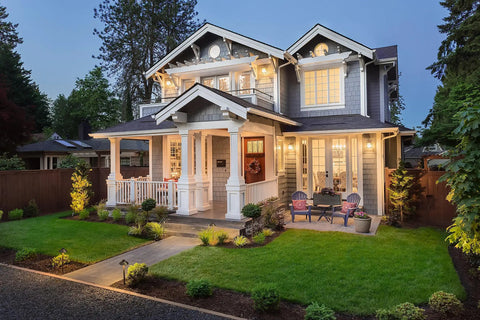 A well-lit yard with Solid Brass Pathway Lights 2 Pack Low Voltage Landscape Walkway Lighting enhancing a classic home.