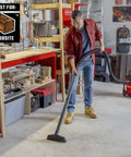 Man using Beast Tough Heavy Duty Wet Dry Vac Attachment Kit For One Seven Eighths Inch Hoses Pro Grade Shop Vacuum in workshop