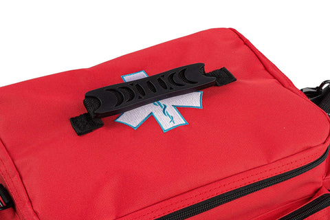 Red emergency medical kit bag with Star of Life patch and black plastic top-handle clip