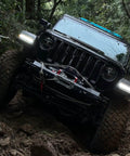 Jeep on rough terrain using Beefed Up Heavy Duty 13500 Pound Electric Winch For Off Road Recovery with 12V DC Power Wireless Remote