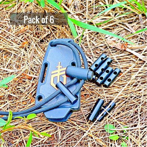 Six Pack 1 Inch Ferro Rod Fire Starter With Two Holes For DIY Paracord Bracelets on grass, shown with paracord tool case.