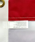 Close-up of Heavy Duty Outdoor US Flag 2.5x4 Ft with brass grommet, fabric label, and sewn stripes, waterproof and UV resistant.