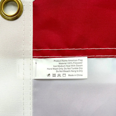 Close-up of Heavy Duty Outdoor US Flag 2.5x4 Ft with brass grommet, fabric label, and sewn stripes, waterproof and UV resistant.