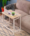 23.6 Inch Mobile Rolling Computer Desk With Wheels Folding Laptop Cart Table For Small Spaces Portable Home Office Desk On Casters Natural And White Finish next to a couch
