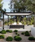 Pergola with 6x6 Post Base Set Of 4 With Inner 5.6x5.6 Post Anchors 13 Gauge Solid Steel Black Powder Coated in a garden setting.