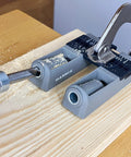 Twin Pocket Hole Jig Set With Adjustable Base And Magnetic Quick Adjust System for woodworking on wooden board with clamp in use.