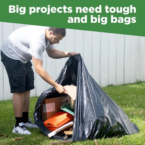 Person using 95 Gallon Extra Large Trash Bags 61x68 Inches 1.2 Mil Thick Beefy Heavy Duty Contractor Bags for outdoor waste storage