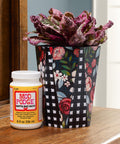Matte Sealer Glue And Finish One Stop Craft Solution For Wood Paper Fabric And More Quick Dry Easy Clean Non Toxic 8 oz bottle next to decorated flower pot