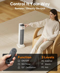 Infrared Patio Heater And Fan Tower For Indoor Use With Remote 1500W Portable Space Heater Three Heat Levels 120 Degree Oscillation 15H Timer Toasty Warmth Quiet Operation Cool Fan And Low High Heat Ideal For Office Living Room Backyard in use in living room with remote displayed