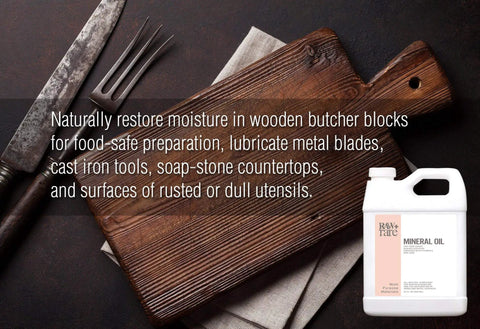 Food Grade Mineral Oil For Wood And Kitchen Surfaces 1 Gallon Vegan Formula bottle next to wooden cutting board and utensils.