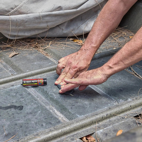Person using Two Ounce Epoxy Putty Stick That Delivers A Fast Hardcore Waterproof Bond For Cars Boats Plumbing And Home Repairs Cures Dark Gray Heat Resistant Up To 350 Fahrenheit Holds Four Tons Chemical And Fuel Resistant on metal surface