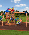 Children playing on Beachfront Cedar Wood Swing Set With Wave Slide Elevated Deck Canopy Monkey Bars Rock Wall Ladder Shaded Picnic Area Snack Bar Window Belt Swings Trapeze Sandbox Playset For Kids in backyard.
