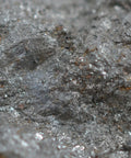 Close-up of Lodestone Specimen about 1 inch natural magnetic rock for classroom demos, showing metallic surface