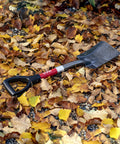 Compact Mini D Handle Square Head Shovel With Soft Grip, on fallen leaves, red and black finish, durable yard tool