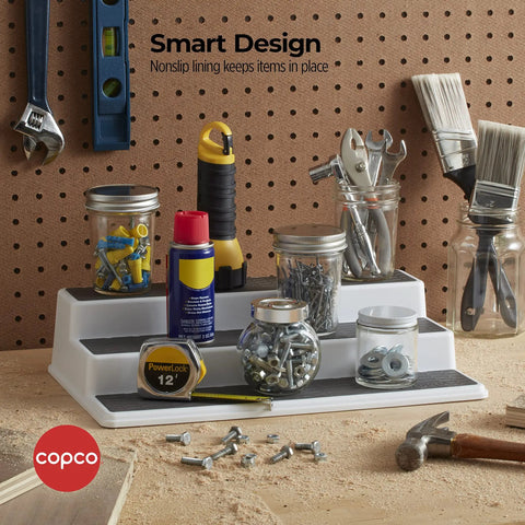 Sleek Three Tier Cabinet Organizer That Straight Up Fixes Pantry Chaos, Non Skid Storage Rack For Spices Seasonings And Canned Goods, White Gray Kitchen Shelf shown in workshop with tools and jars.