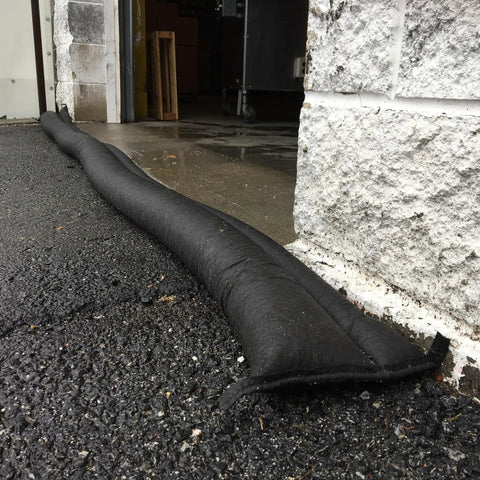 Water Activated Flood Barrier 5 Feet Pack Black placed near building to divert flood water