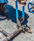16 Inch Tongue And Groove Pliers With Laser Heat Treated Teeth in use fixing a metal pipe outdoors
