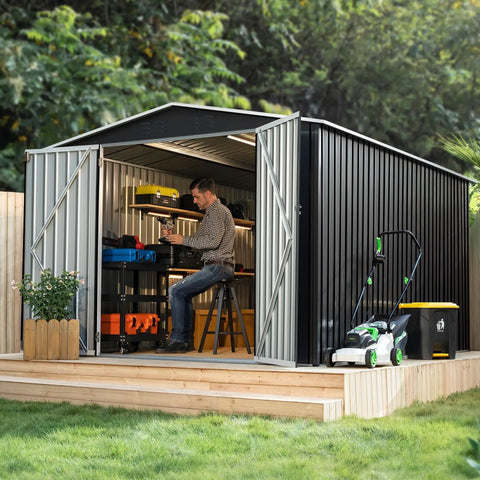 Person working inside 8 By 12 Ft Outdoor Metal Storage Shed With Updated Frame Structure, Weatherproof Tool Shed For Backyard Garden Patio Lawn, Easy Assembly, Heavy Duty Construction, UV Resistant Powder Coat, Black.