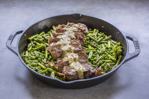 Cast Iron Dual Handle Skillet 12 Inch Preseasoned Black with Even Heat Distribution and Secure Grip Handles with steak and vegetables