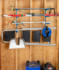 Four Tier Lumber Rack Wall Mounted Shop Organizer For Garage And Basement, holding skis and tools, on wooden wall in garage