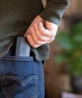 Person placing Minnow Driver Kit Pocket Sized Screwdriver And Portable Bit Set For On The Go Fixes into jeans back pocket