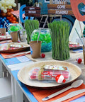 18 Piece Mini Fishing Tackle Box Party Favors Set Colorful Candy Stash Boxes displayed on decorated birthday table