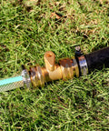 Solid Brass Garden Hose Repair Kit with Stainless Steel Clamps, Swivel Fittings and Three Quarter Inch Adapters on Grass