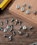 24 Pack Must Have Facemask Hardware Kit For Helmets With 12mm And 8mm Screws displayed on a wooden surface