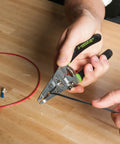 Using Stainless Steel Wire Stripper For 10-18 AWG Solid And 12-20 AWG Stranded on blue wire on table with connectors