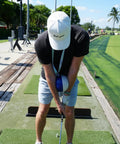 Golfer using Compression Ball Golf Swing Trainer For Perfect Impact And Forearm Connection on driving range