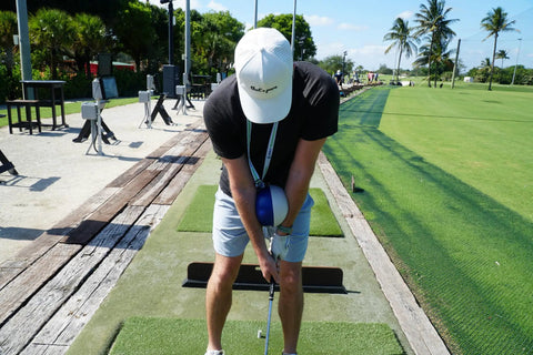 Golfer using Compression Ball Golf Swing Trainer For Perfect Impact And Forearm Connection on driving range