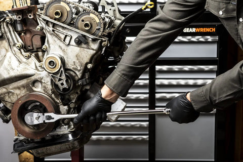 Mechanic using One Half Inch Drive 84 Tooth Locking Flex Head Teardrop Ratchet, 24 Inch Length on engine in workshop
