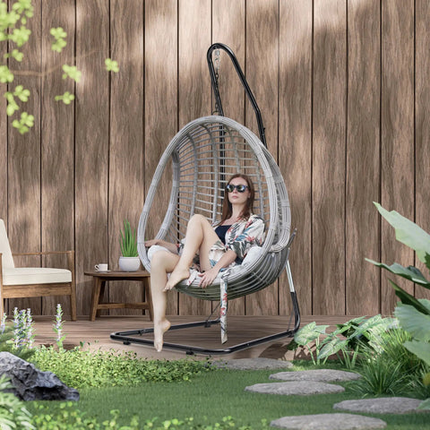 Woman sitting on Heavy Duty Hammock Chair Stand With Adjustable Steel Frame Built To Last, Weatherproof And Rust Resistant Swing Stand, 330 Lb Capacity, Portable For Indoor Outdoor Patio Or Tree, Lounger And Porch