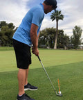 Golfer using Magnetic Golf Alignment Rods for Instant Swing Feedback on green, visualizing upright, flat, square lie angles, orange