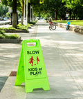 Bright Green Slow Down Kids At Play Sign For Street Caution Children Playing Outdoor Safety Sign For Driveways Yards And Neighborhood Roads 3 Pack Durable Weatherproof Plastic Set on sidewalk
