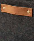 Close-up of Hella Spacious Rectangular Felt Storage Basket With Faux Leather Handles, showing gray felt and tan leather handle.
