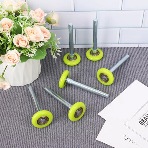 Top Shelf 15 Pack 1.8 Inch Green Nylon Garage Door Rollers Featuring Quiet 6200ZZ Precision Ball Bearings For Lightning Smooth Residential Door Replacement displayed with flowers.